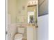 Cozy half bathroom featuring a pedestal sink, decorative mirror, and wainscoting at 1368 Grebe Dr, Punta Gorda, FL 33950