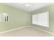 Clean, empty bedroom featuring a large window, neutral paint and tile, and a ceiling fan at 1368 Grebe Dr, Punta Gorda, FL 33950