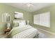 Bright bedroom with a ceiling fan, large window, and a comfy bed with green accents at 1368 Grebe Dr, Punta Gorda, FL 33950