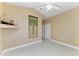 Spacious bedroom with modern tile floors and a palm tree tapestry at 1368 Grebe Dr, Punta Gorda, FL 33950