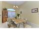 Dining room with ample natural light, chandelier, and stylish furnishings at 1368 Grebe Dr, Punta Gorda, FL 33950