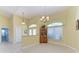 Bright dining room with tile floors, chandelier, and natural light from large windows at 1368 Grebe Dr, Punta Gorda, FL 33950
