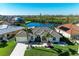 Beautiful home with a tile roof, lush landscaping, and waterfront views at 1368 Grebe Dr, Punta Gorda, FL 33950