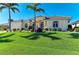 Charming home with well-manicured lawn, palm trees, and a welcoming facade at 1368 Grebe Dr, Punta Gorda, FL 33950