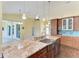 Modern kitchen boasts granite counters, stainless appliances, and pendant lighting at 1368 Grebe Dr, Punta Gorda, FL 33950