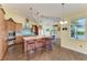 Kitchen with a large island, modern appliances, wooden cabinets, and stylish pendant lighting at 1368 Grebe Dr, Punta Gorda, FL 33950