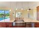 Spacious kitchen features granite counters, stainless steel sink, and backyard pool view at 1368 Grebe Dr, Punta Gorda, FL 33950