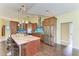 Kitchen boasting a center island with bar seating, wooden cabinets, stainless steel appliances, and pendant lights at 1368 Grebe Dr, Punta Gorda, FL 33950