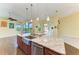 Kitchen features granite countertops, stainless sink, and sliding door to lanai at 1368 Grebe Dr, Punta Gorda, FL 33950