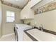 Functional laundry room with a washer, dryer, utility sink, and overhead cabinets at 1368 Grebe Dr, Punta Gorda, FL 33950