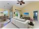Open-concept living room with patio access, ceiling fan, and modern decor at 1368 Grebe Dr, Punta Gorda, FL 33950