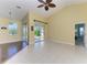 Well-lit living room with neutral walls and tile flooring leading to a patio at 1368 Grebe Dr, Punta Gorda, FL 33950