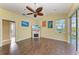 Cozy living room with fan, tile floors, television, and sliding door to outside view at 1368 Grebe Dr, Punta Gorda, FL 33950