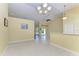 Spacious living area with tile flooring, neutral walls, and elegant light fixtures at 1368 Grebe Dr, Punta Gorda, FL 33950