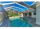 This screened in pool has a brick pool deck and a nice view of the home's exterior at 1368 Grebe Dr, Punta Gorda, FL 33950
