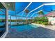 Screened in pool overlooking the water, brick pavers, and tropical landscaping at 1368 Grebe Dr, Punta Gorda, FL 33950
