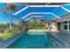 A screened in pool with brick pool deck and nearby manicured landscaping gives a resort-like vibe at 1368 Grebe Dr, Punta Gorda, FL 33950