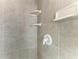 Tiled shower featuring built in storage shelves at 1368 Grebe Dr, Punta Gorda, FL 33950