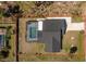 Aerial view of a single-Gathering home with a screened-in pool and spacious backyard at 14195 Brisk Ave, Port Charlotte, FL 33953