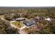 Aerial view showing the house, backyard, and surrounding trees at 14195 Brisk Ave, Port Charlotte, FL 33953