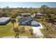 Aerial view of a home with a long driveway and mature landscaping at 14195 Brisk Ave, Port Charlotte, FL 33953