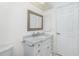 Bright bathroom featuring a white vanity with a marble countertop, a framed mirror, and neutral wall color at 14195 Brisk Ave, Port Charlotte, FL 33953