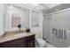 Bright bathroom features a granite counter, updated fixtures, and a glass enclosed shower at 14195 Brisk Ave, Port Charlotte, FL 33953