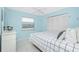Light blue bedroom with a queen bed, white furniture, and natural light at 14195 Brisk Ave, Port Charlotte, FL 33953