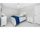 Cozy bedroom with tile floors, white furniture, and a comfortable bed with plush pillows and blankets at 14195 Brisk Ave, Port Charlotte, FL 33953