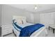 Comfortable bedroom offers a full sized bed, a dresser, and a ceiling fan at 14195 Brisk Ave, Port Charlotte, FL 33953