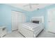 Bright blue bedroom with a queen bed, white furniture, and built in closets at 14195 Brisk Ave, Port Charlotte, FL 33953