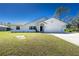 Charming single-story home featuring a two-car garage and well-maintained front lawn at 14195 Brisk Ave, Port Charlotte, FL 33953