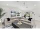 Bright living room features vaulted ceilings, large windows, and comfortable sectional sofa at 14195 Brisk Ave, Port Charlotte, FL 33953