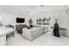 Spacious living room featuring modern decor, tile flooring, and large windows at 14195 Brisk Ave, Port Charlotte, FL 33953