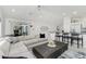 Open concept living area with breakfast bar, cozy seating, and sliding glass doors to backyard at 14195 Brisk Ave, Port Charlotte, FL 33953