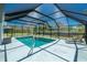 Screened-in pool with clear blue water, a seating area, and a relaxing ambiance at 14195 Brisk Ave, Port Charlotte, FL 33953