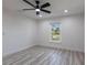 Bright bedroom features modern ceiling fan, recessed lighting, and wood-look flooring at 160 Green Pine Park, Rotonda West, FL 33947