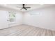 Bright bedroom features modern ceiling fan, recessed lighting, and wood-look flooring at 160 Green Pine Park, Rotonda West, FL 33947