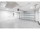 Spacious garage with epoxy flooring, modern door, and ample lighting at 160 Green Pine Park, Rotonda West, FL 33947