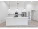 Modern kitchen featuring white cabinetry, a large center island, and stainless-steel appliances at 160 Green Pine Park, Rotonda West, FL 33947