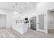 Modern kitchen with stainless steel appliances, white cabinetry, and a sleek island, perfect for meal preparation and entertaining at 160 Green Pine Park, Rotonda West, FL 33947