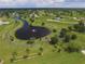 Aerial view of the community showcasing a lake, winding paths and green spaces at 16271 Branco Dr, Punta Gorda, FL 33955