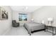 Bedroom with a window view, artwork, ceiling fan, and hardwood floors at 16271 Branco Dr, Punta Gorda, FL 33955