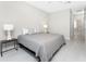 Bedroom with natural light, hardwood floors, ceiling fan, and two side tables with lamps at 16271 Branco Dr, Punta Gorda, FL 33955