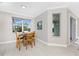 Well-lit dining area features a large window, tile flooring and connection with the outdoor areas of the home at 16271 Branco Dr, Punta Gorda, FL 33955