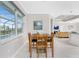 Comfortable dining area with views of the pool, adjacent to an open-concept living space at 16271 Branco Dr, Punta Gorda, FL 33955