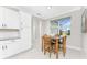 Cozy dining area with natural light, white cabinets and views to the exterior and other areas of the home at 16271 Branco Dr, Punta Gorda, FL 33955