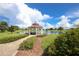 Scenic gazebo overlooking a tranquil lake with walking path access at 16271 Branco Dr, Punta Gorda, FL 33955