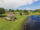 Aerial shot of gazebo with lake view and beautifully landscaped grounds at 16271 Branco Dr, Punta Gorda, FL 33955