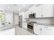 Well-equipped kitchen with stainless steel appliances, white cabinetry and ample counter space at 16271 Branco Dr, Punta Gorda, FL 33955